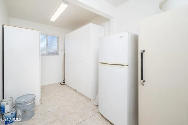 a white refrigerator freezer sitting inside of a kitchen