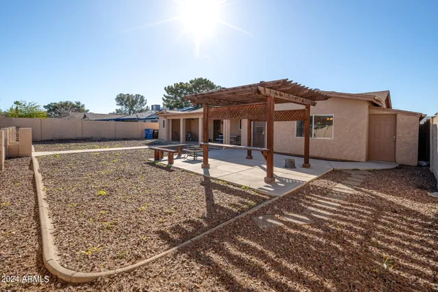 a view of a house with a wooden fence