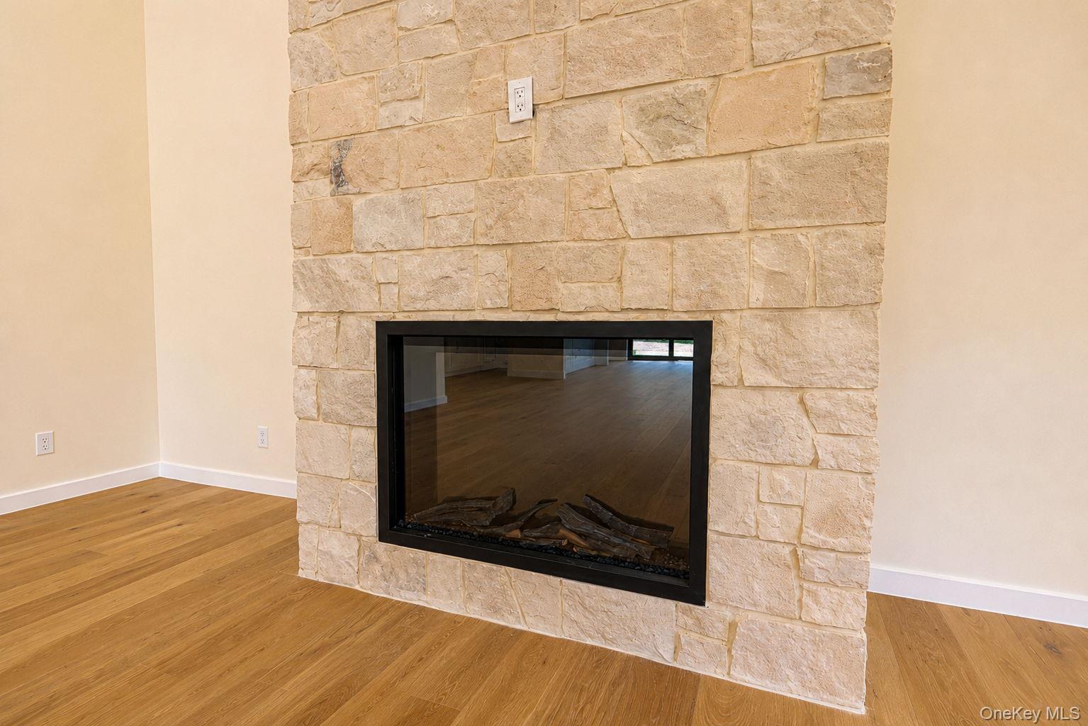 128 St Elmo Road Wallkill, NY 12589 - Photo 16 of 45 Stone-clad fireplace featuring a black-framed glass-fronted insert