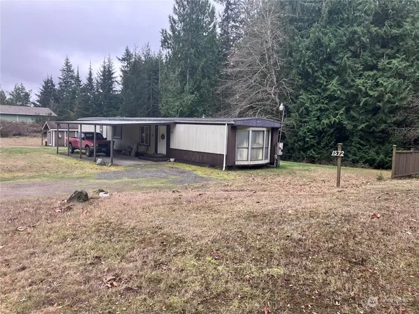 a backyard of a house with barbeque oven
