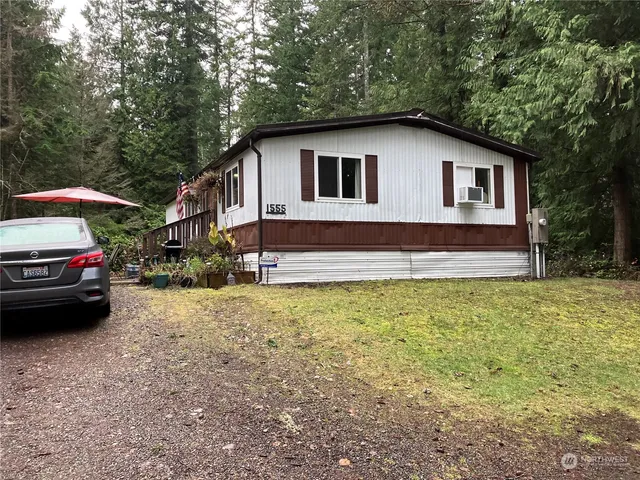 a car parked in front of a house with a yard