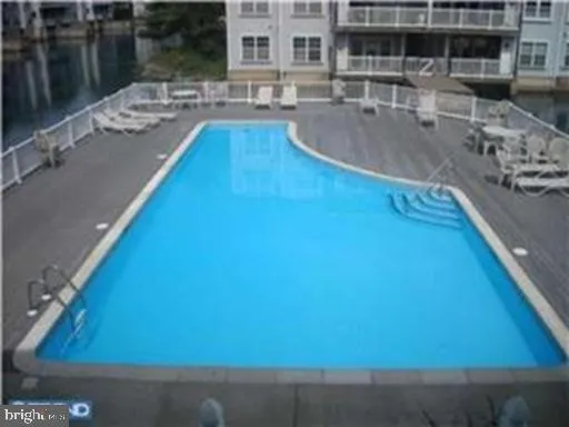 a view of a swimming pool with outdoor seating