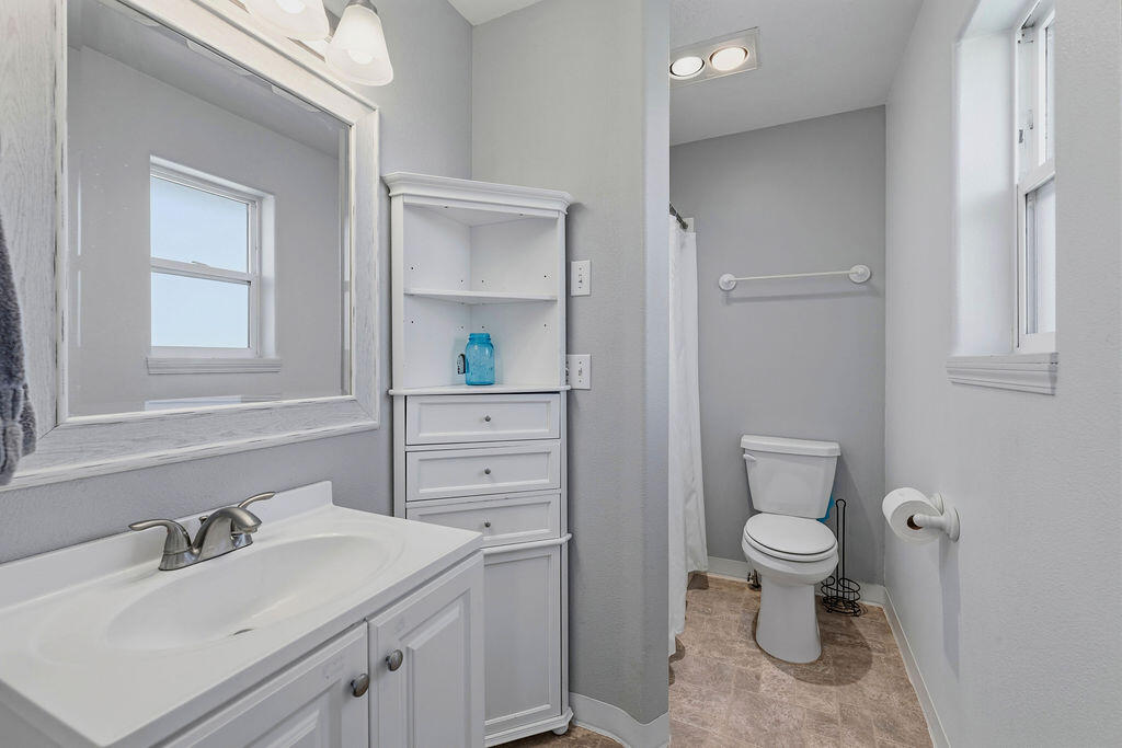 2979 Northeast Sugar Pine Road Prineville, OR 97754 - Photo 8 of 31 a bathroom with a granite countertop toilet sink and mirror