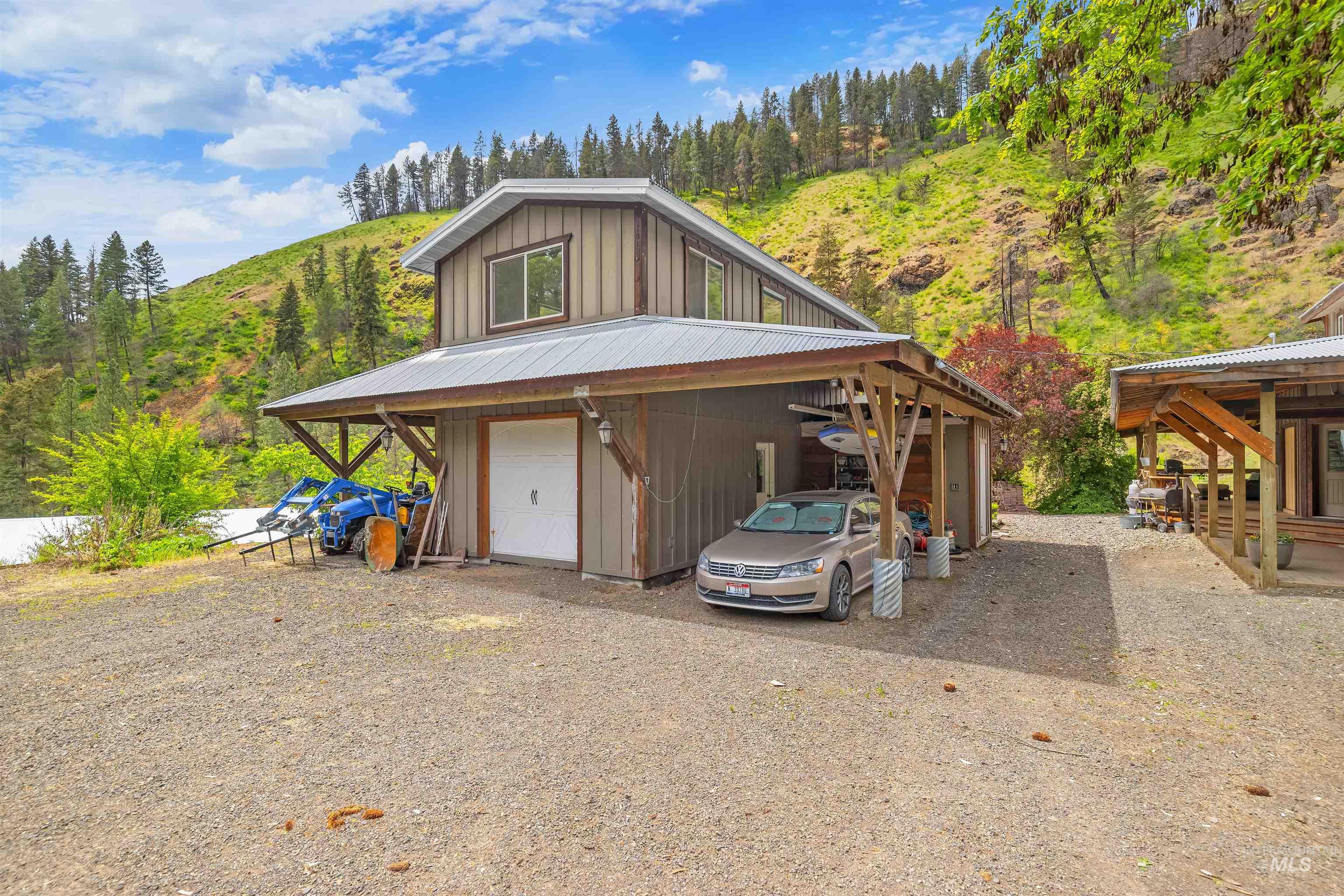 1314 Cedar Ridge Road Kendrick, ID 83537 - Photo 5 of 50 Two-story structure with board-and-batten siding, a metal roof, and an attached carport