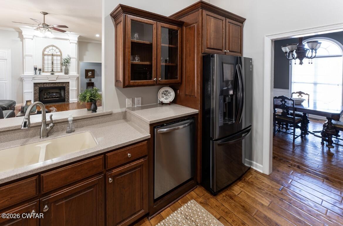 9 Shadow Ridge Drive Jackson, TN 38305 - Photo 19 of 25 a kitchen with stainless steel appliances granite countertop a refrigerator a stove and a sink with wooden floor