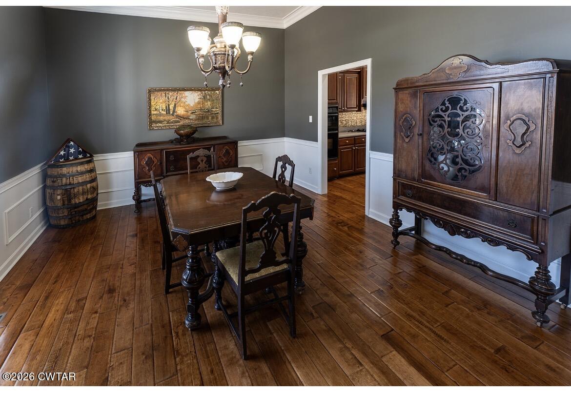 9 Shadow Ridge Drive Jackson, TN 38305 - Photo 6 of 25 a view of a dining room with furniture a chandelier and wooden floor