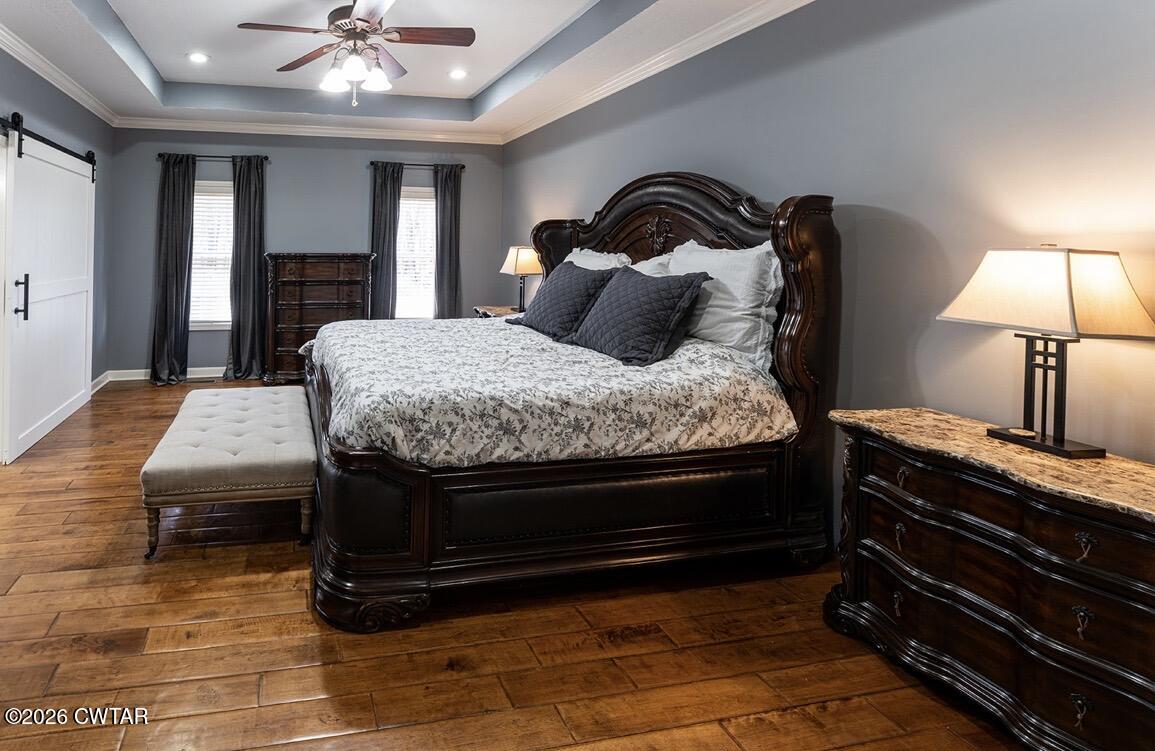 9 Shadow Ridge Drive Jackson, TN 38305 - Photo 9 of 25 a bedroom with a bed and a chandelier