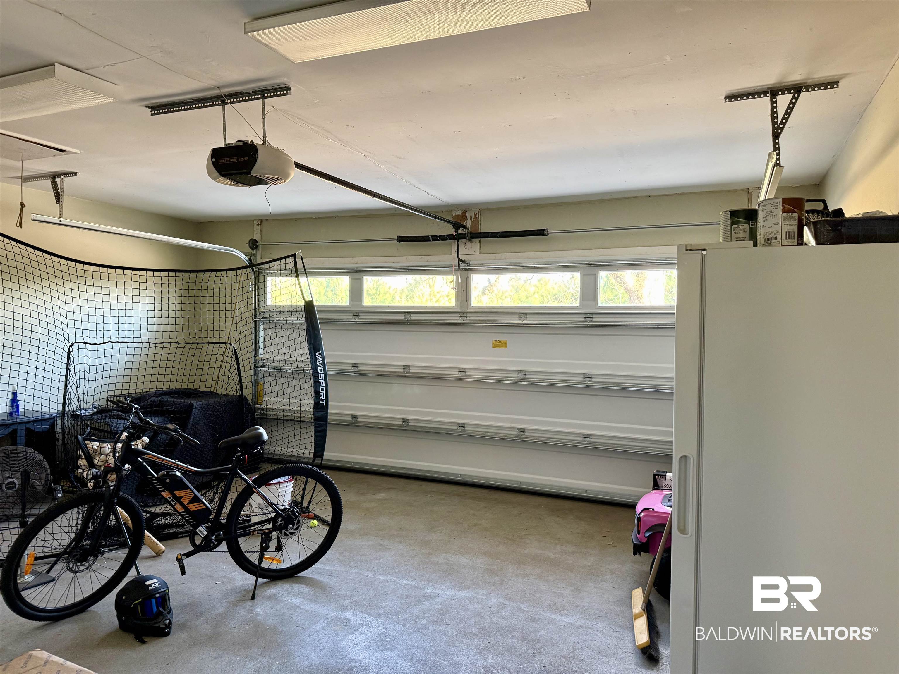 5646 Foshee Road Brewton, AL 36426 - Photo 26 of 37 Garage with freestanding refrigerator and a garage door opener