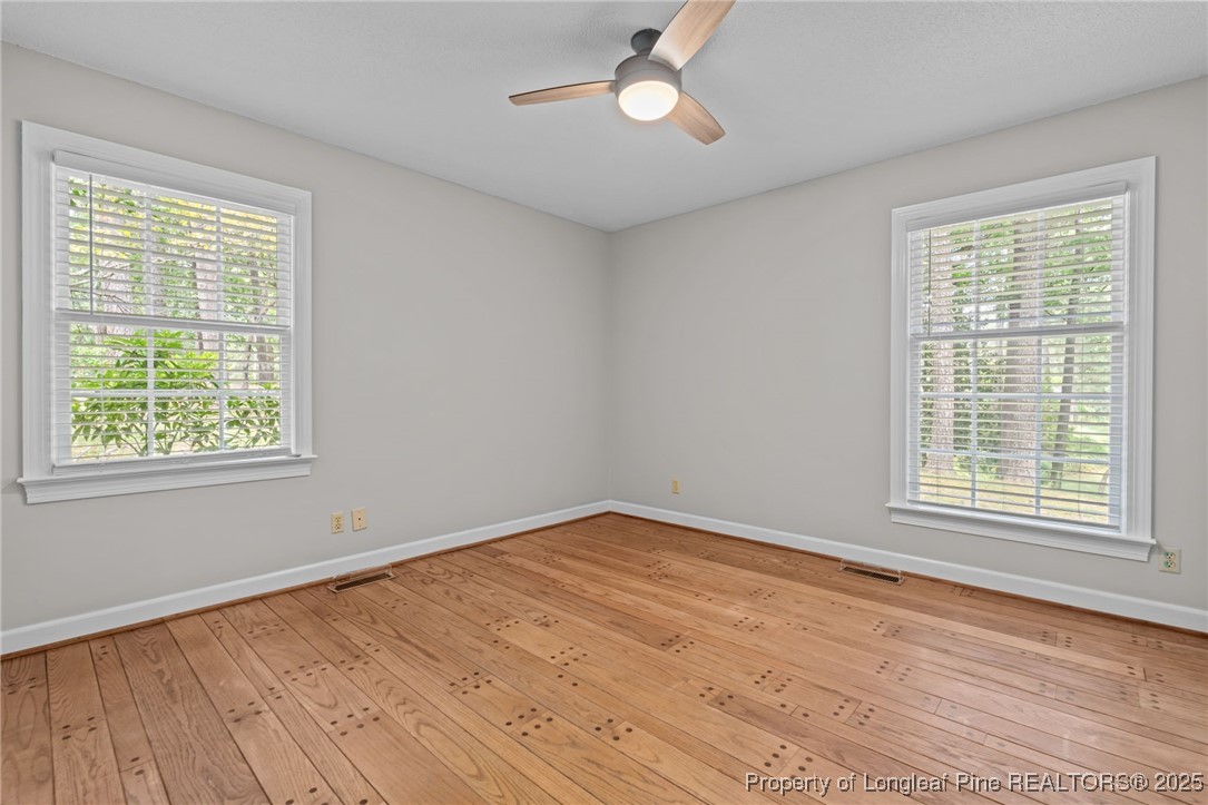 610 Maynard Lake Road Erwin, NC 28339 - Photo 16 of 49 a view of an empty room with wooden floor and a window