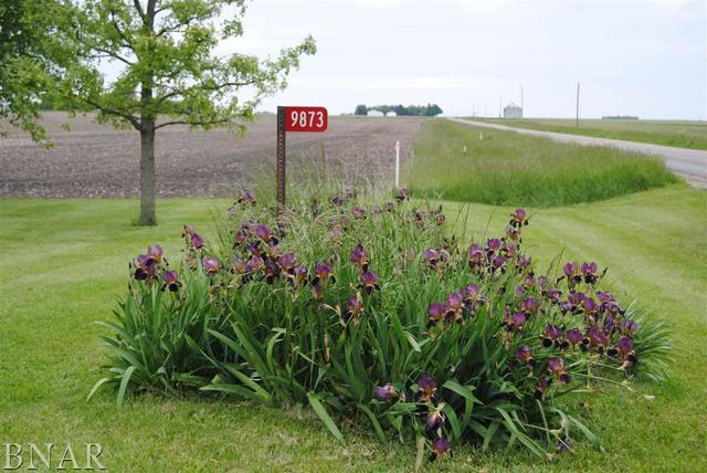 9873 Birkbeck Road Clinton, IL 61727 - Photo 5 of 8 a sign that is sitting in the grass next to a road