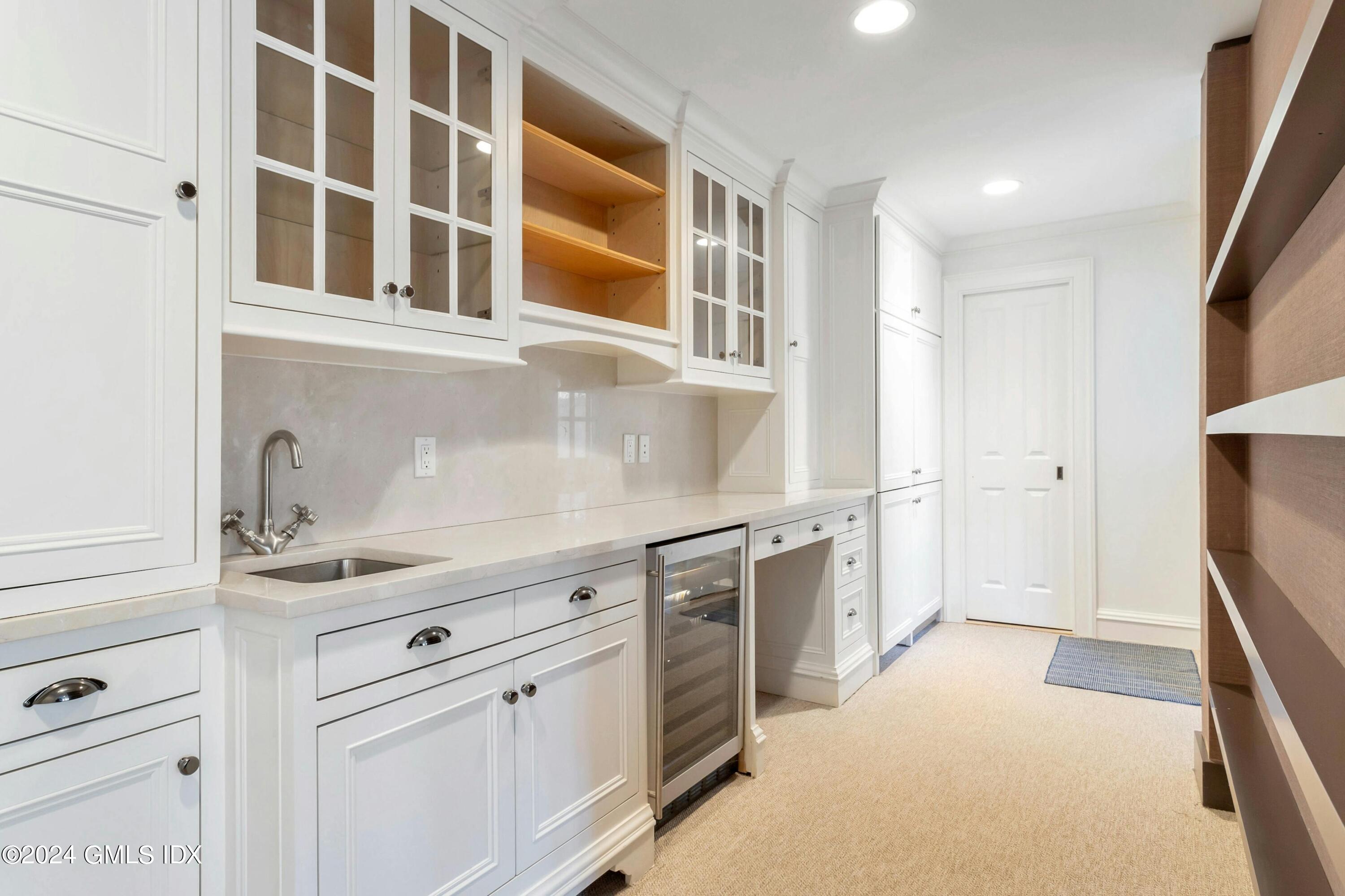 71 Fairfield Road Greenwich, CT 06830 - Photo 15 of 24 a kitchen with stainless steel appliances granite countertop a sink and a refrigerator