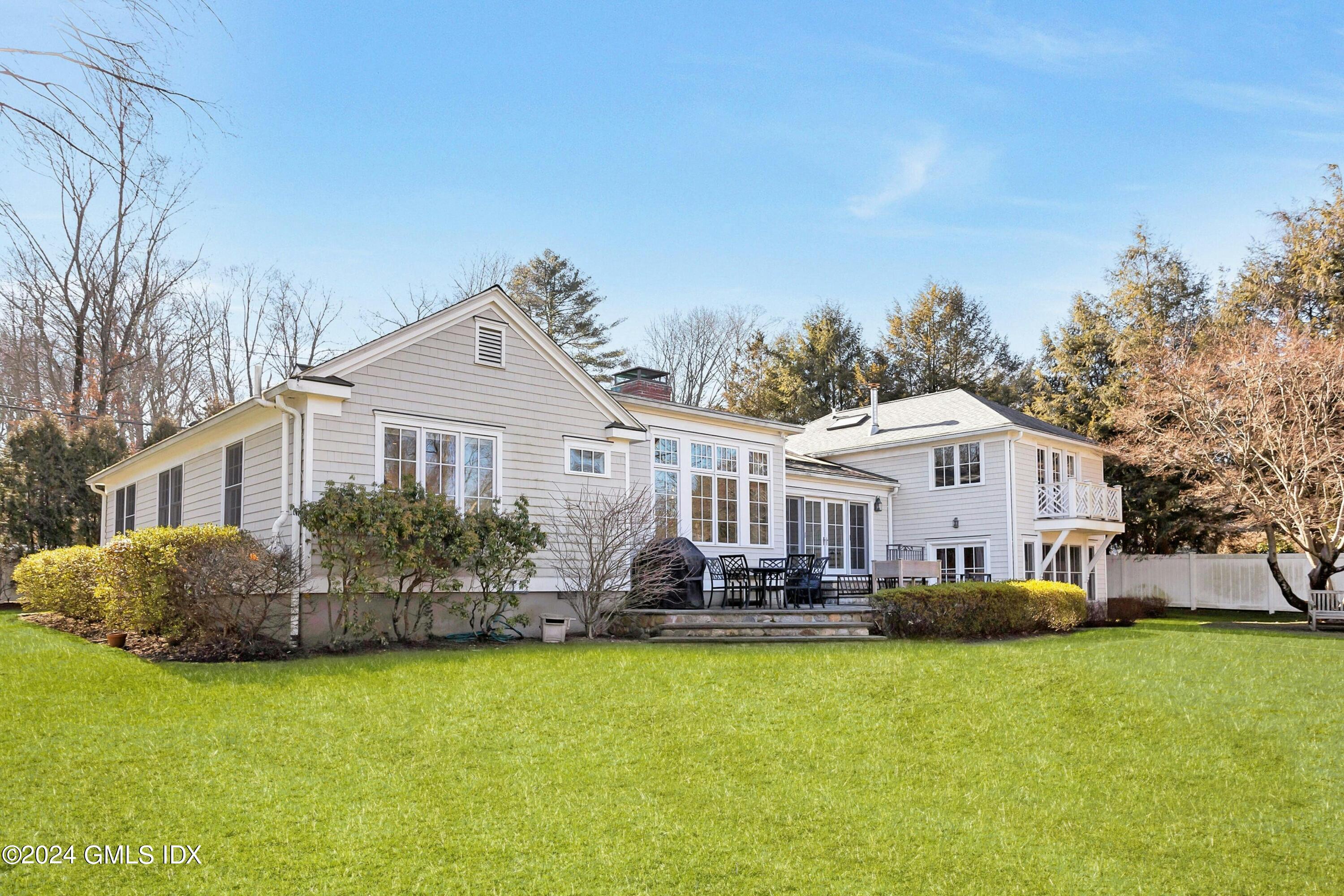 71 Fairfield Road Greenwich, CT 06830 - Photo 2 of 24 a front view of house with yard and trees in the background