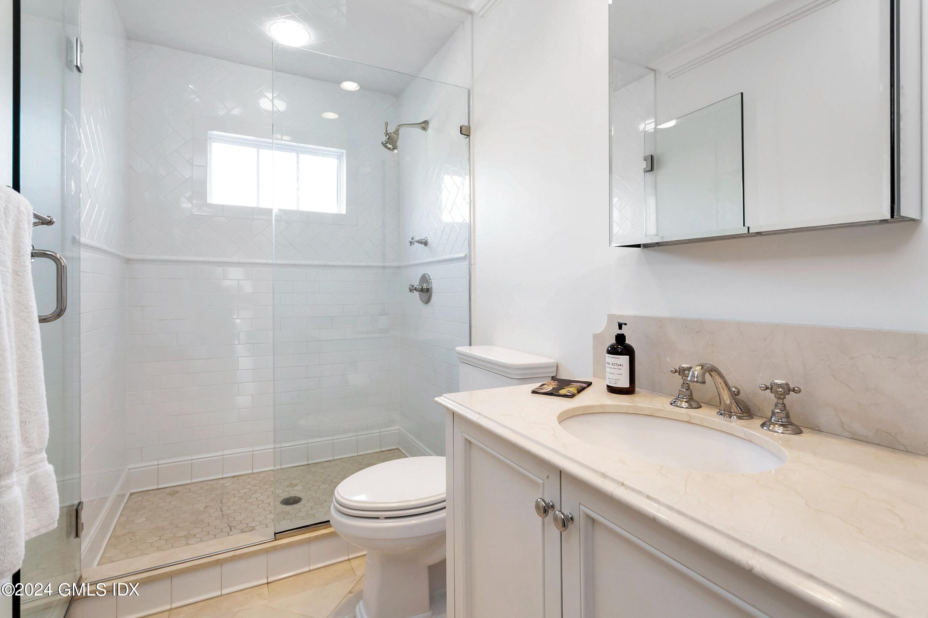 71 Fairfield Road Greenwich, CT 06830 - Photo 21 of 24 a bathroom with a granite countertop sink a toilet and shower