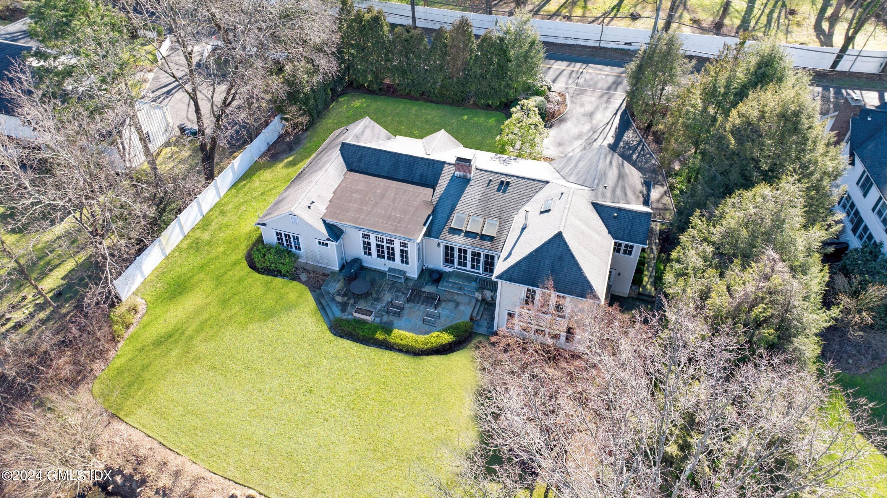 71 Fairfield Road Greenwich, CT 06830 - Photo 4 of 24 a aerial view of a house with swimming pool and large trees