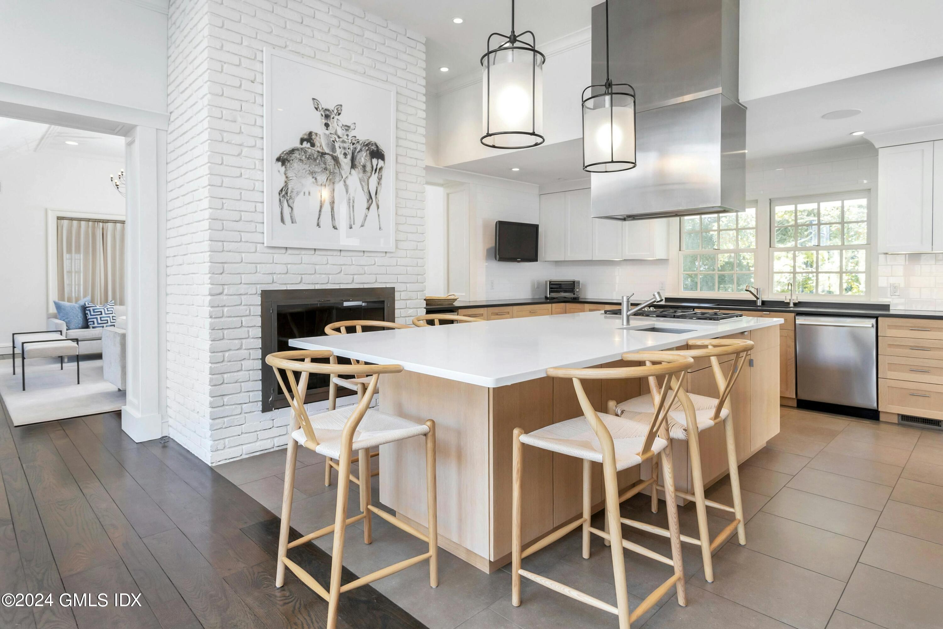 71 Fairfield Road Greenwich, CT 06830 - Photo 7 of 24 a white kitchen with a stove a table and chairs in it