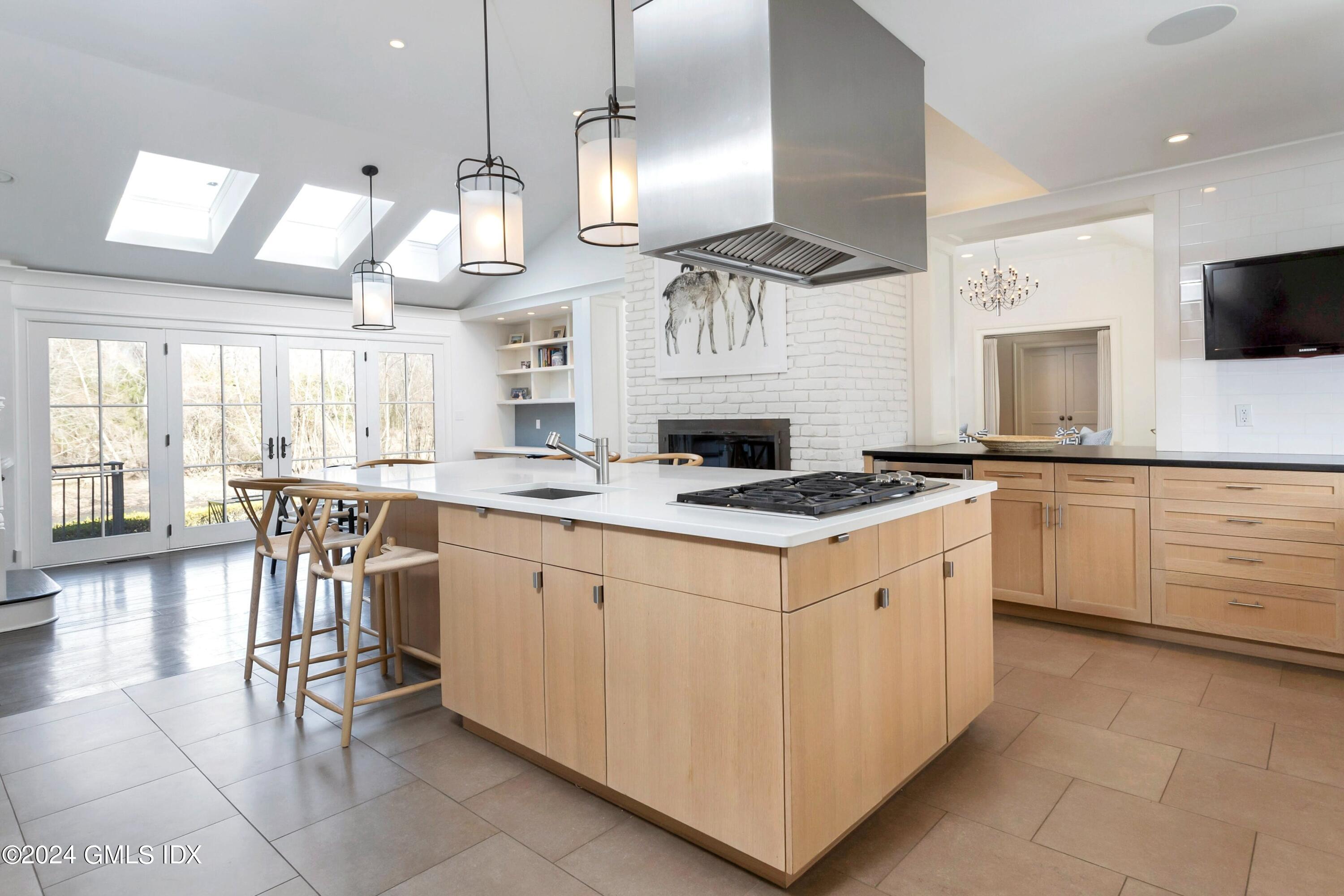 71 Fairfield Road Greenwich, CT 06830 - Photo 9 of 24 a large kitchen with cabinets chairs and a view of living room