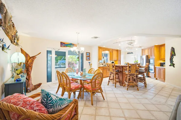 a large kitchen with kitchen island a large counter space a sink appliances and a counter top space