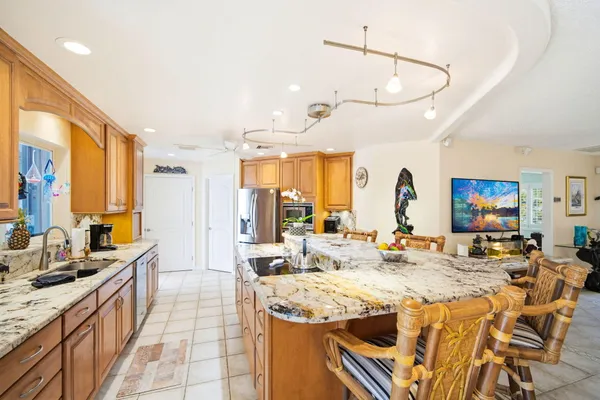 a very nice looking dining room with a large window and kitchen view