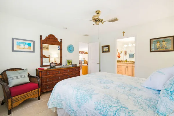 a spacious bathroom with a granite countertop sink a mirror a shower and a bathtub