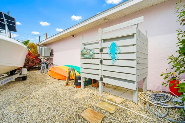 a view of a house with a yard and sitting area