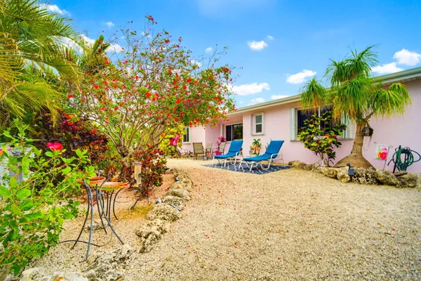 a view of a swimming pool with lawn chairs