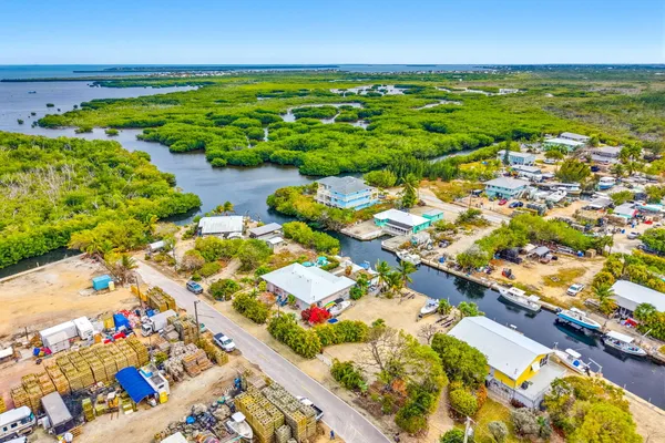 a view of a lake with lawn chairs
