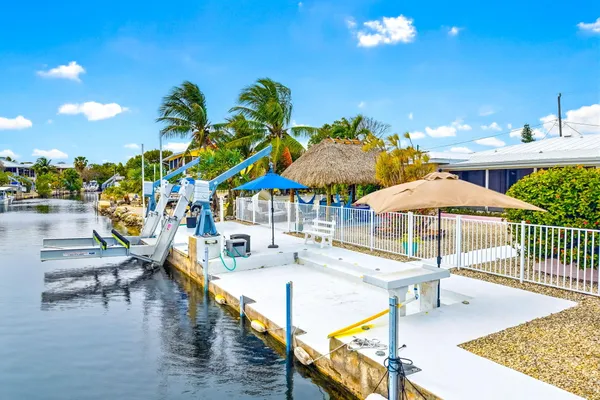 a view of a chairs and table in patio with a lake view
