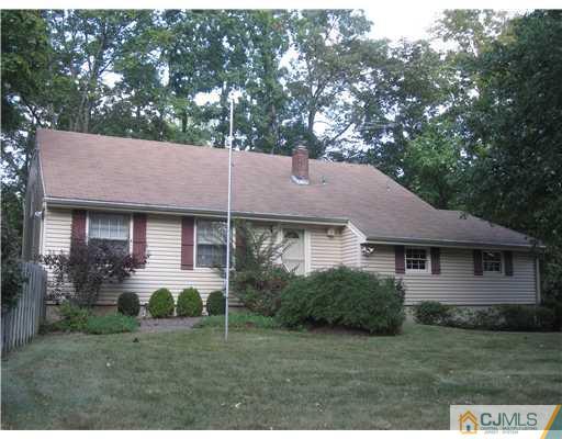 18 Timber Road Edison, NJ 08820 - Photo 1 of 13 a front view of a house with a yard and garage