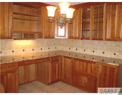 18 Timber Road Edison, NJ 08820 - Photo 4 of 13 a kitchen with granite countertop a sink and a window