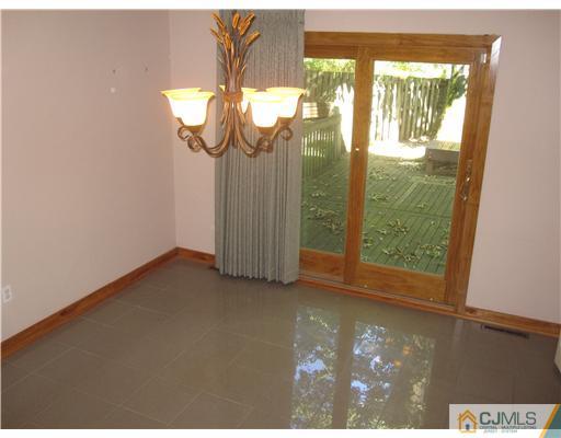 18 Timber Road Edison, NJ 08820 - Photo 6 of 13 a view of empty room with wooden floor and fan