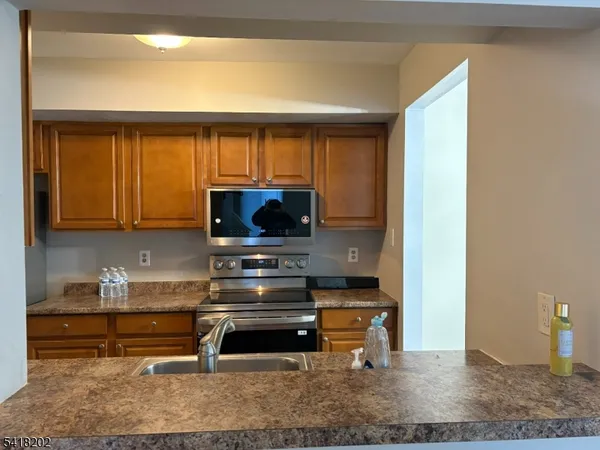 a kitchen with wooden cabinets and a sink