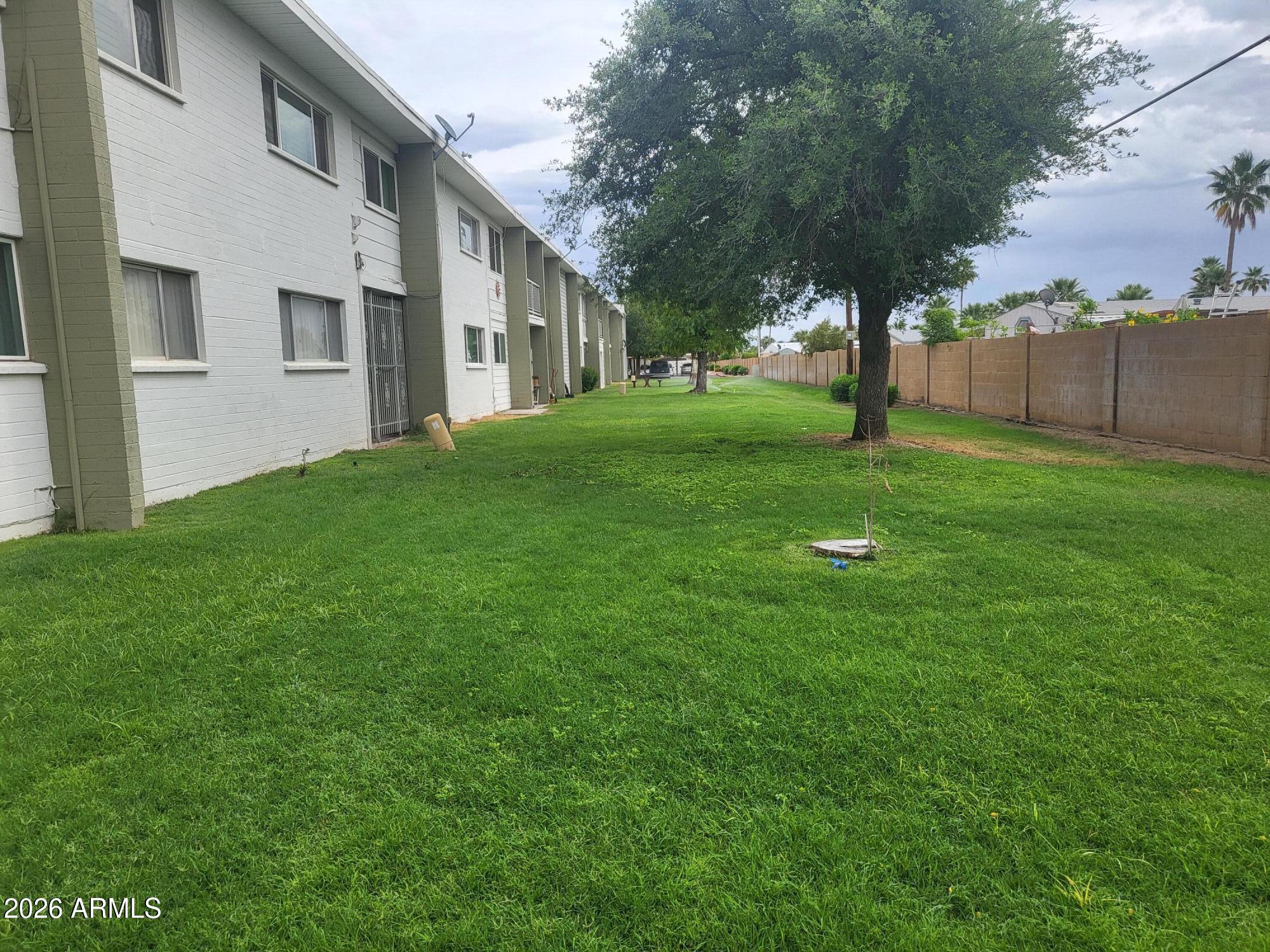 815 North Hayden Road, Unit B109 Scottsdale, AZ 85257 - Photo 14 of 25 a view of a white house next to a yard with a tree