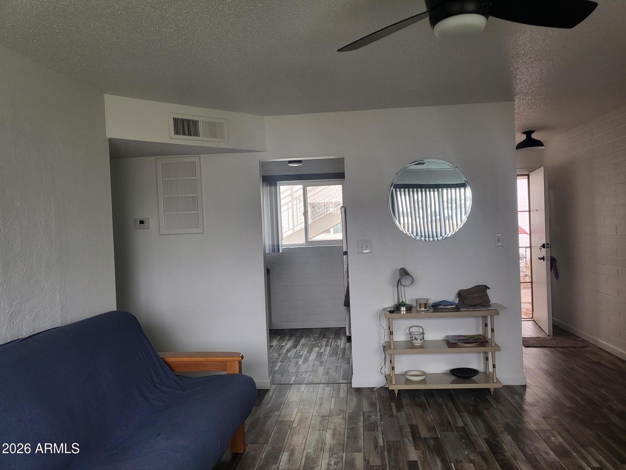 815 North Hayden Road, Unit B109 Scottsdale, AZ 85257 - Photo 3 of 25 a living room with furniture and wooden floor