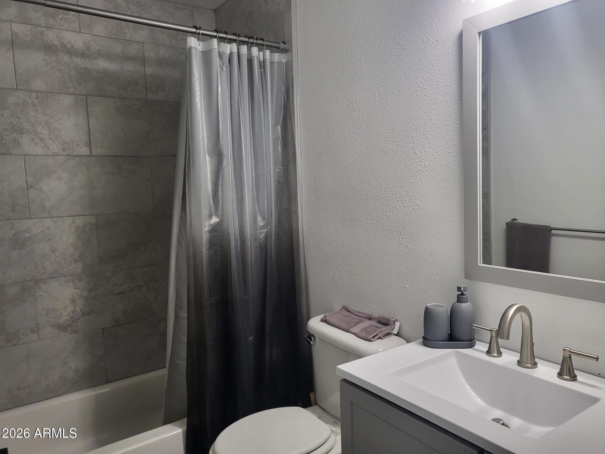 815 North Hayden Road, Unit B109 Scottsdale, AZ 85257 - Photo 8 of 25 a bathroom with a sink a toilet and shower