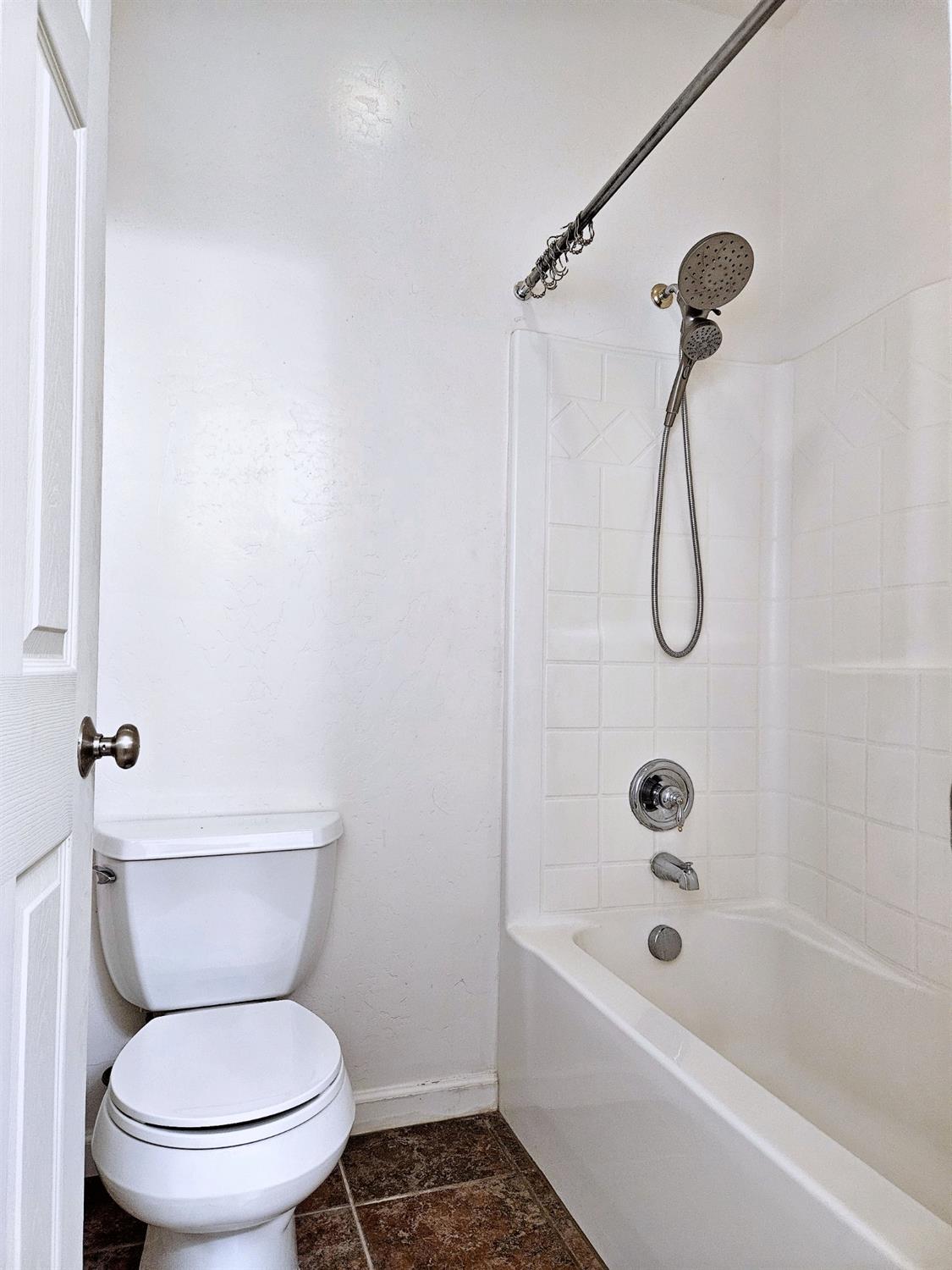 828 Tureaud Lane Clovis, CA 93619 - Photo 19 of 24 a white toilet sitting next to a bath tub and a shower