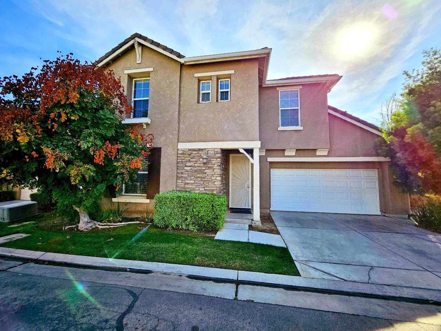 828 Tureaud Lane Clovis, CA 93619 - Photo 2 of 24 a front view of a house with a yard and garage