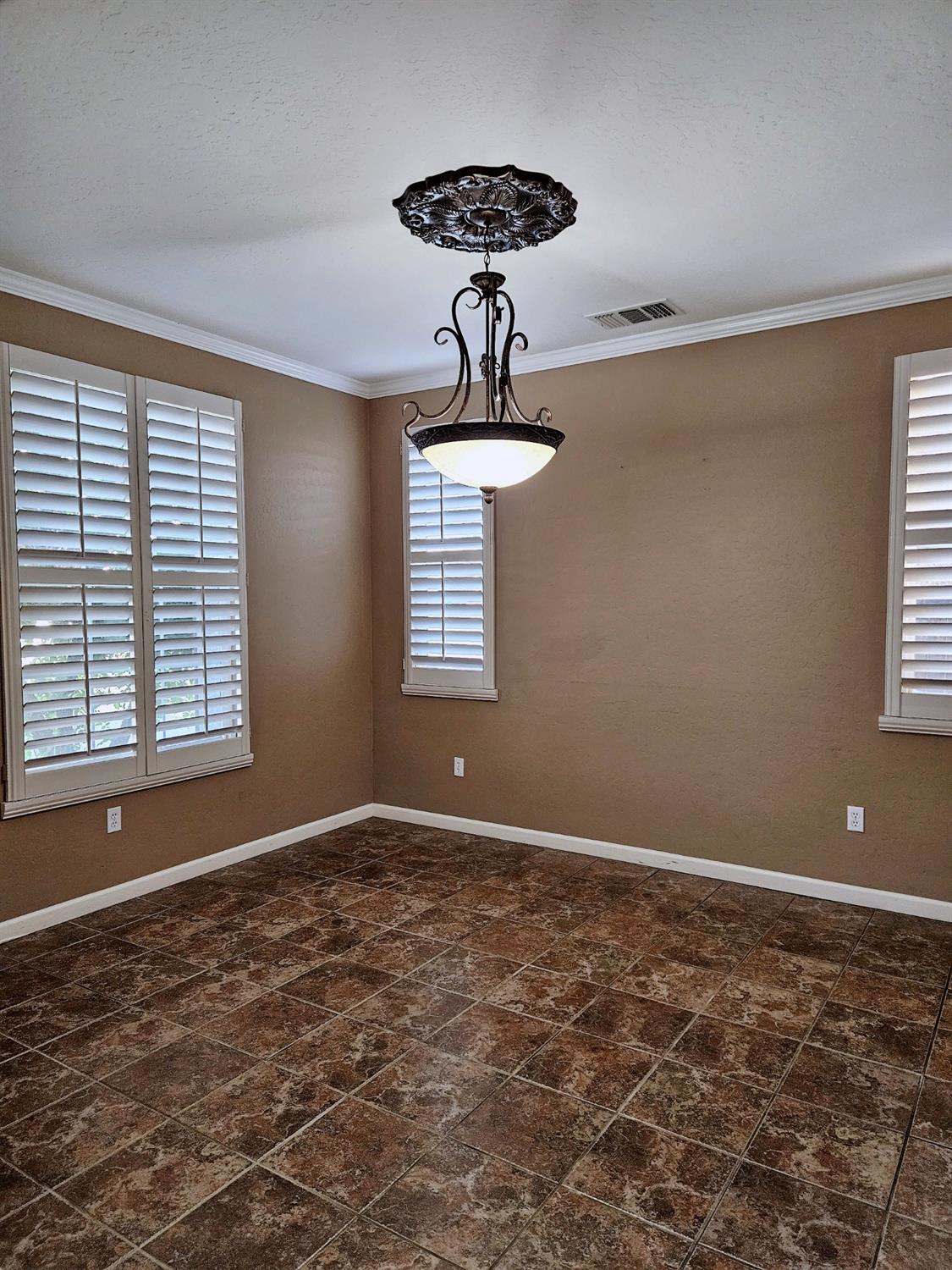 828 Tureaud Lane Clovis, CA 93619 - Photo 4 of 24 a view of wooden floor and windows in a room