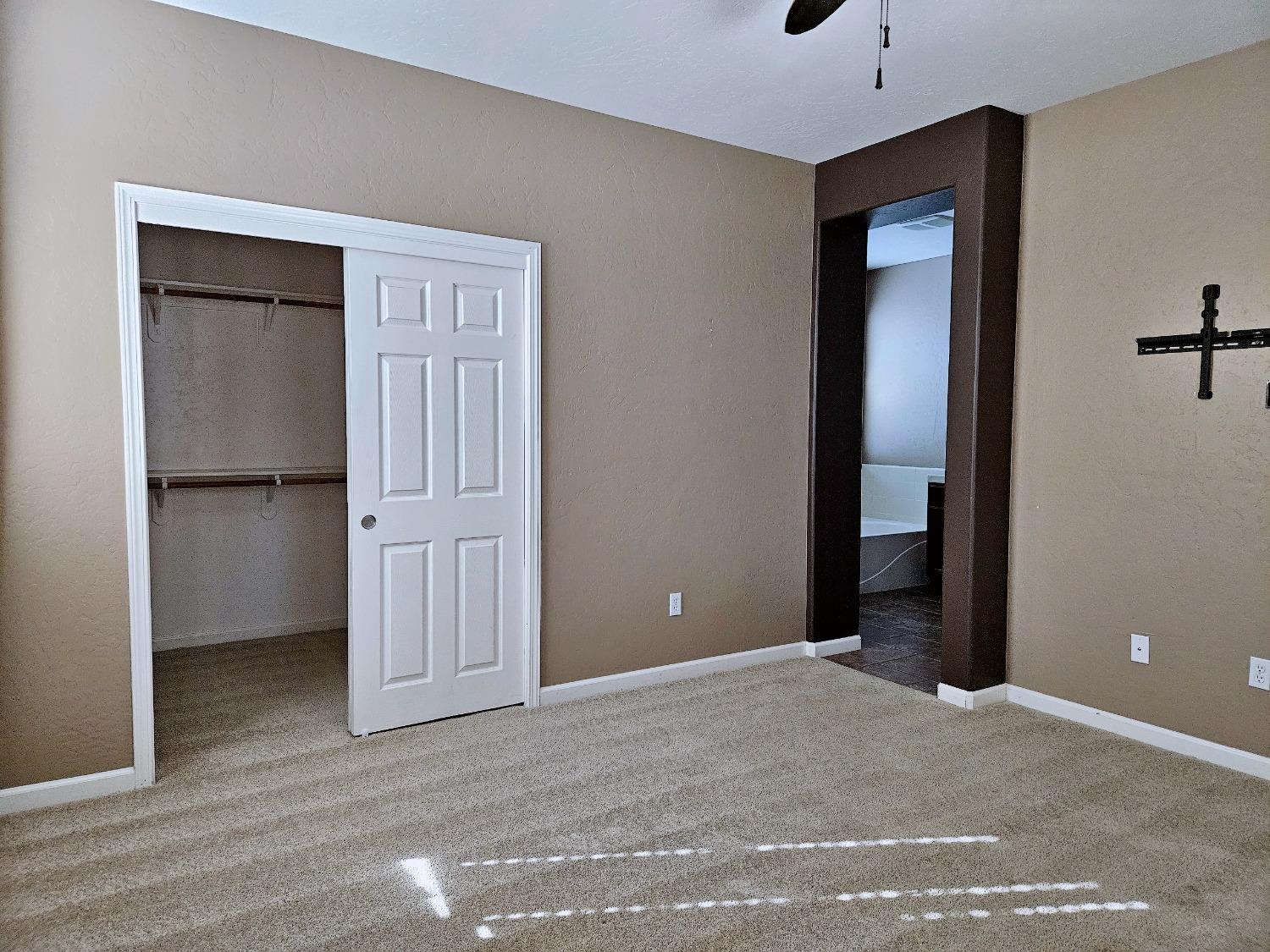 828 Tureaud Lane Clovis, CA 93619 - Photo 7 of 24 an empty room with closet and windows