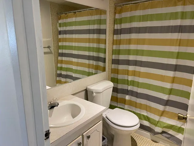 a kitchen with stainless steel appliances white cabinets and a refrigerator