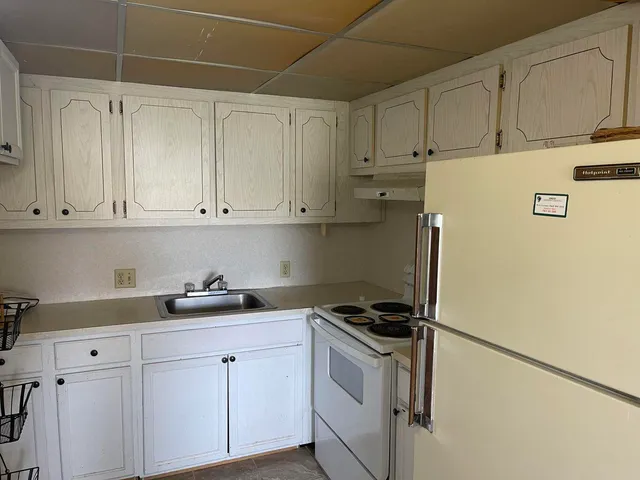 a kitchen with cabinets and appliances