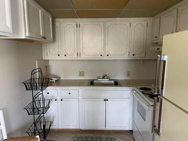 a view of a dining room with furniture and window