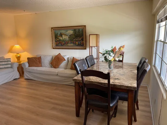 a living room with furniture and a lamp