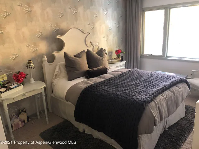 a view of balcony with two chairs and a potted plant