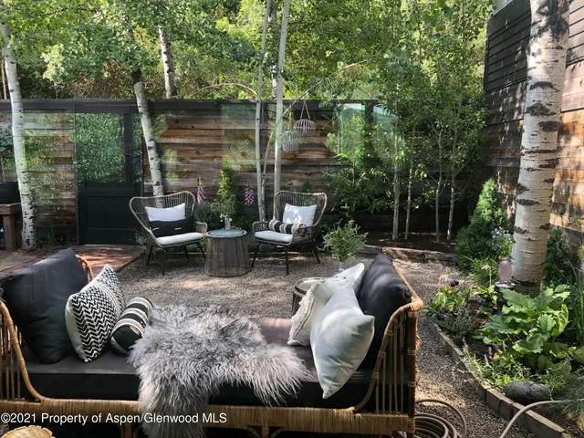 a view of a backyard with sitting area