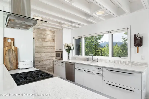 a kitchen with a window a sink and a stove
