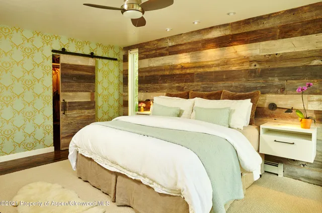 a bedroom with a bed and a night stand