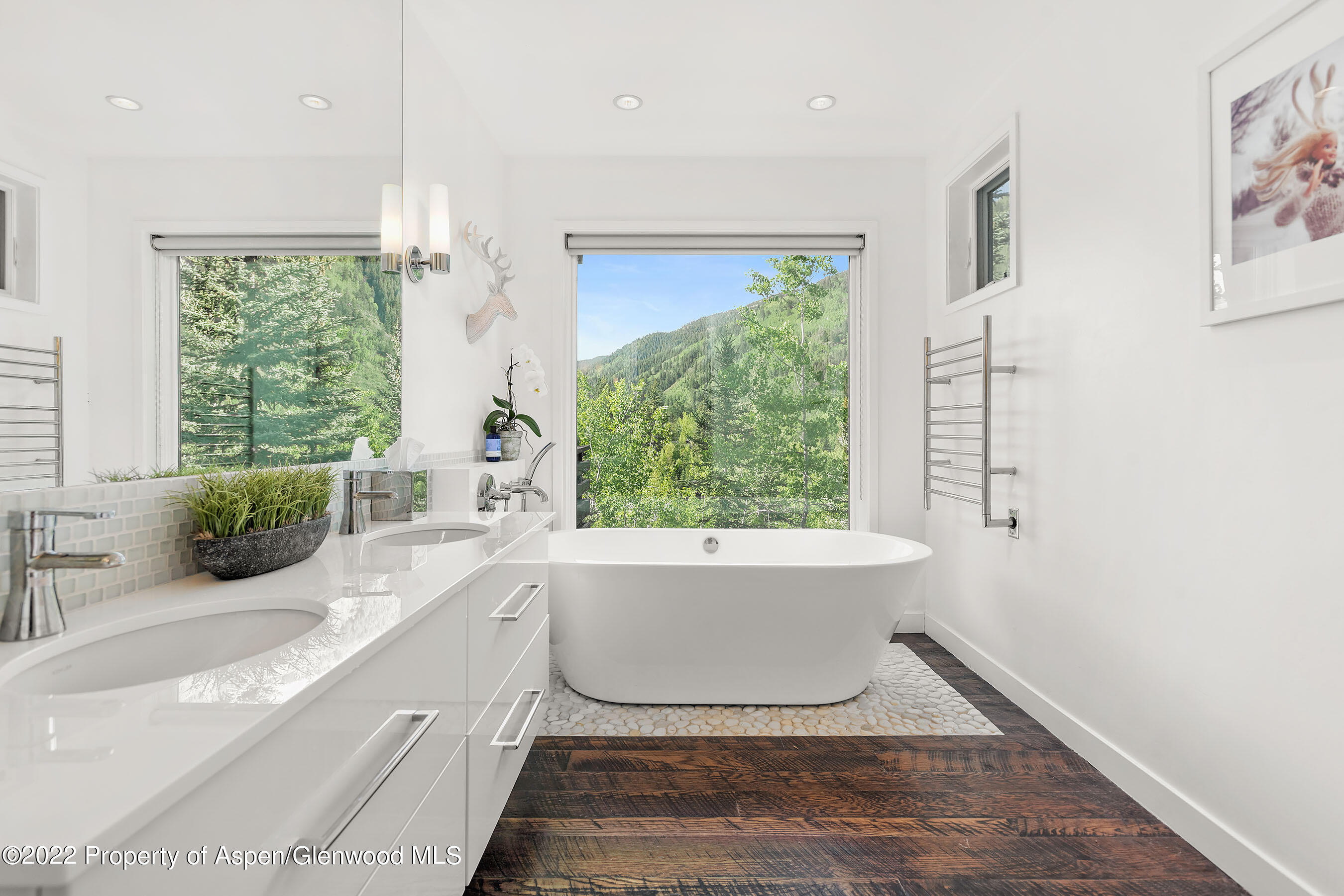 122 Eastwood Road Aspen, CO 81611 - Photo 9 of 22 a white bath tub sitting in a bathroom next to a window
