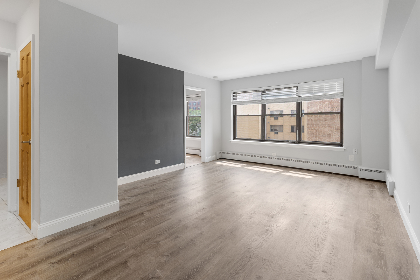 5858 North Sheridan Road, Unit 806 Chicago, IL 60660 - Photo 2 of 13 an empty room with wooden floor and windows