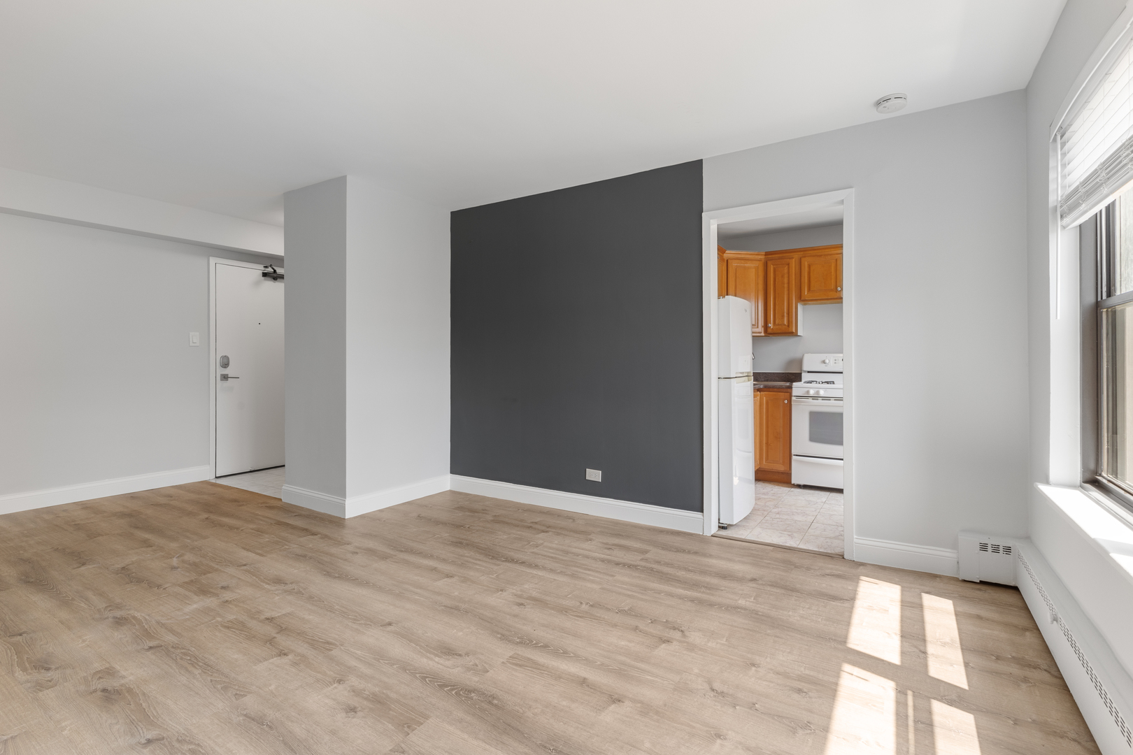 5858 North Sheridan Road, Unit 806 Chicago, IL 60660 - Photo 3 of 13 a view of an empty room with window and wooden floor