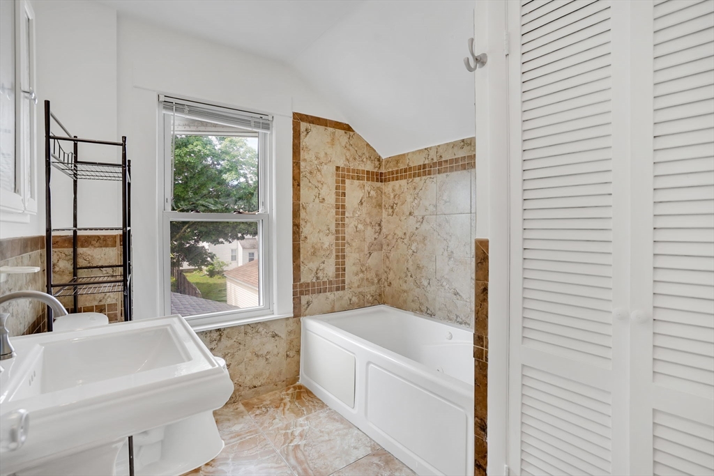 184 Arthur Street Springfield, MA 01104 - Photo 28 of 39 a bathroom with a sink a bathtub and next to a window